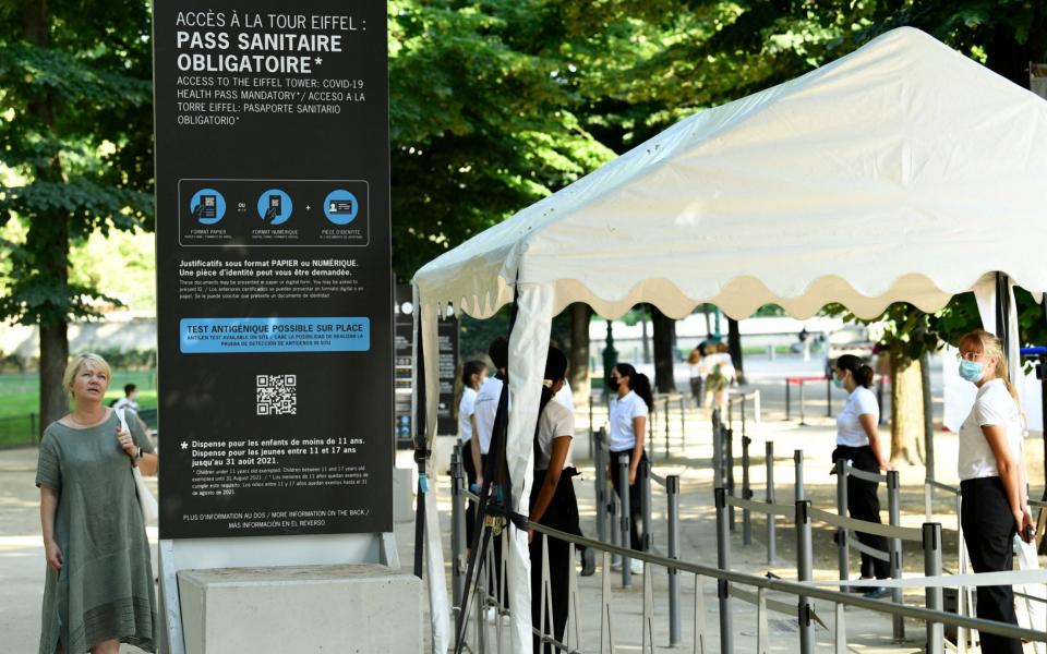 Employees of the Eiffel Tower check clients's health passes before they visit the Eiffel Tower, in Paris, - Getty