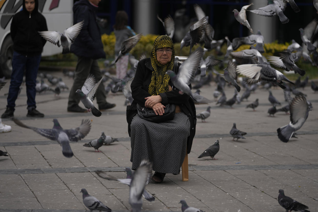 A woman rests outside her home in Duzce, Turkey, Wednesday, Nov. 23, 2022, after a magnitude 5.9 earthquake hit a town in northwest Turkey early Wednesday, causing damage to some buildings and widespread panic. At least 68 people were injured, mostly while trying to flee homes. The earthquake was centered in the town of Golkaya, in Duzce province, some 200 kilometers (125 miles) east of Istanbul, the Disaster and Emergency Management Presidency said.(AP Photo/Khalil Hamra)