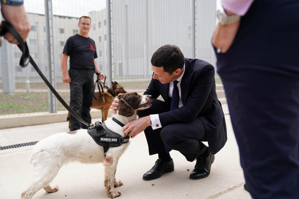 Secretary of State for Justice and Lord Chancellor Alex Chalk meets a search dog as he attends the official opening of HMP Fosse Way, the new Category C prison in Leicester. Picture date: Thursday June 29, 2023. (Photo by Jacob King/PA Images via Getty Images)