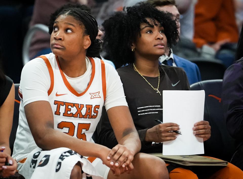 Texas forward Madison Booker, left, and guard Rori Harmon sit on the bench together during a game against the Kansas Jayhawks at Moody Center last month. The Longhorns won the game 91-56.