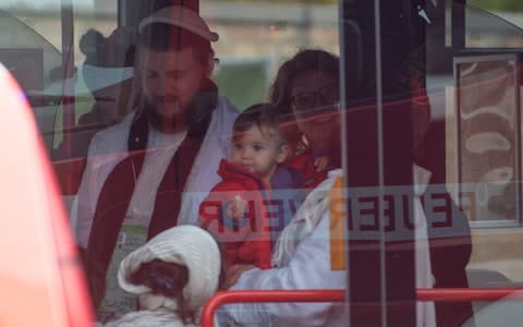 A child and other survivors from the Synagogue shooting in Halle (Saale) board a bus and are taken to safety, Several hours after the assault - Credit: Craig Stennett for the Telegraph