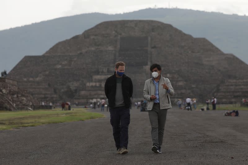 Visitors walk as they wear protective masks during the start of the gradual reopening of the ancient ruins of Teotihuacan