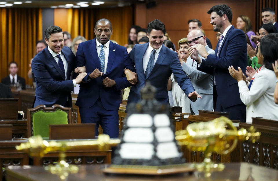 Newly elected Speaker of the House of Commons Greg Fergus is escorted into the House of Commons by Prime Minister Justin Trudeau and Conservative Leader Pierre Poilievre on Parliament Hill in Ottawa on Tuesday, Oct. 3, 2023. THE CANADIAN PRESS/Sean Kilpatrick