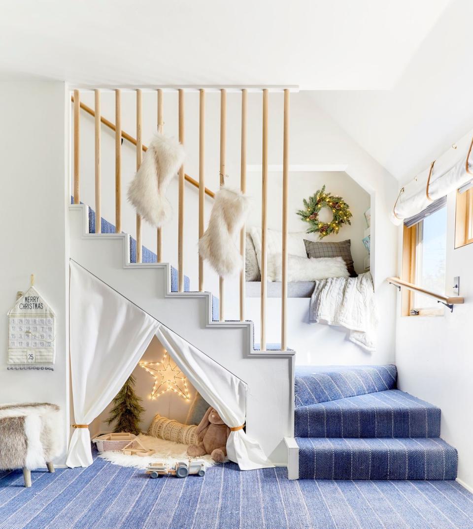 white staircase with blue rug and white fur stockings