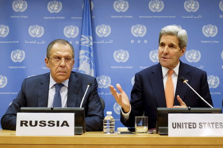 Russia's Foreign Minister Sergey Lavrov (L) listens to U.S. Secretary of State John Kerry during a news conference at the United Nations Headquarters in Manhattan, New York, December 18, 2015. REUTERS/Eduardo Munoz