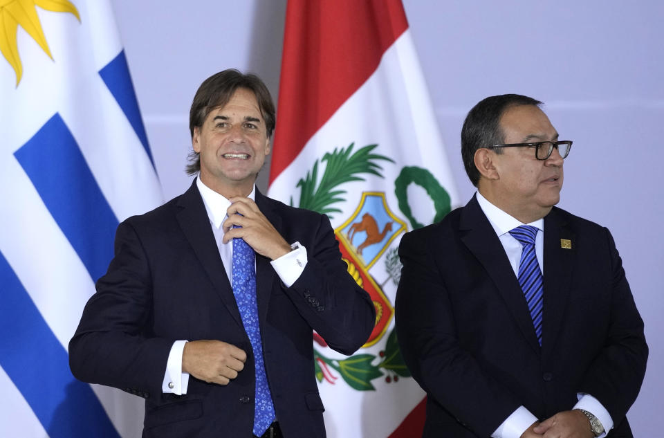 Uruguay's President Luis Lacalle Pou, left, and Prime Minister of Peru Alberto Otarola, take their places as they assemble for a group photo during the South American Summit at Itamaraty palace in Brasilia, Brazil, Tuesday, May 30, 2023. South America's leaders are gathering as part of Brazil's President Luiz Inacio Lula da Silva's attempt to reinvigorate regional integration efforts. (AP Photo/Andre Penner)