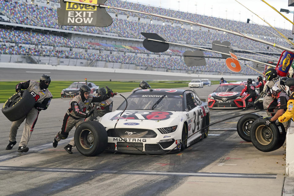 FILE - Michael McDowell makes a pit stop for fuel and tires during the NASCAR Cup Series road course auto race at Daytona International Speedway in Daytona Beach, Fla., in this Sunday, Feb. 21, 2021, file photo. Michael McDowell followed his Daytona 500 victory with a pair of top-10 finishes. That's three in three races, one shy of his total from all of 2020. Perhaps his Front Row Motorsports team really has turned the corner. (AP Photo/John Raoux, File)