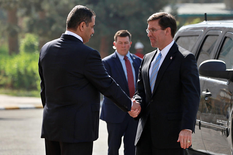 Visiting U.S. Defense Secretary Mark Esper, right, shakes hands with Iraqi Defense Minister Najah al-Shammari, left, during a welcome ceremony at the Ministry of Defense, Baghdad, Iraq, Wednesday, Oct. 23, 2019. Esper has arrived in Baghdad on a visit aimed at working out details about the future of American troops that are withdrawing from Syria to neighboring Iraq. (AP Photo/Hadi Mizban)