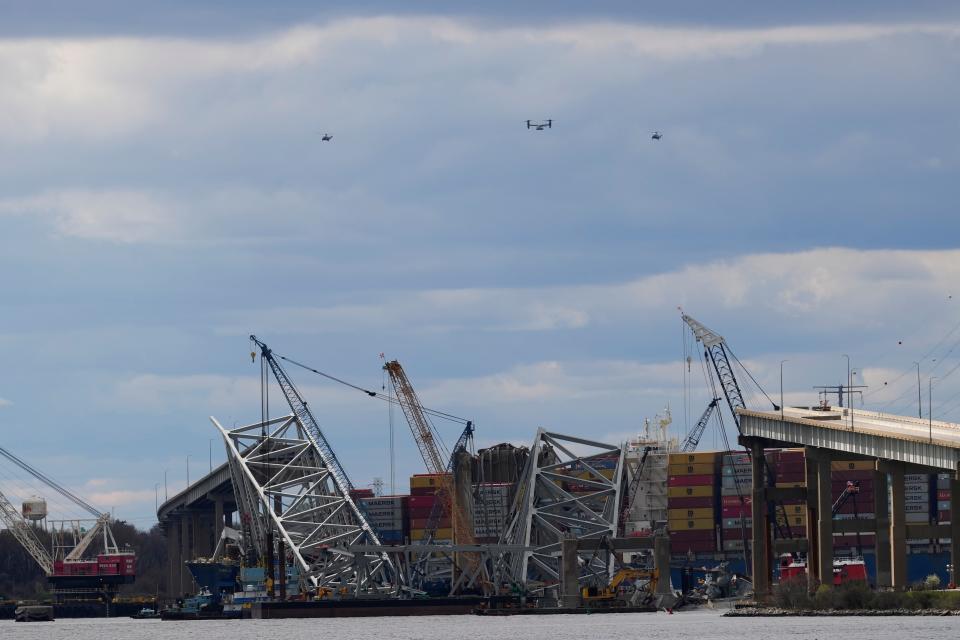 A fleet of helicopters, including Marine One carrying U.S. President Joe Biden, circles the site of the collapsed Francis Scott Key Bridge.