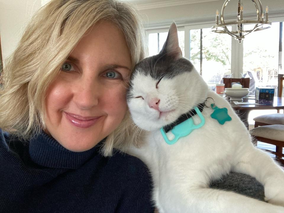 Courtenay Rudzinski smiling with a cat