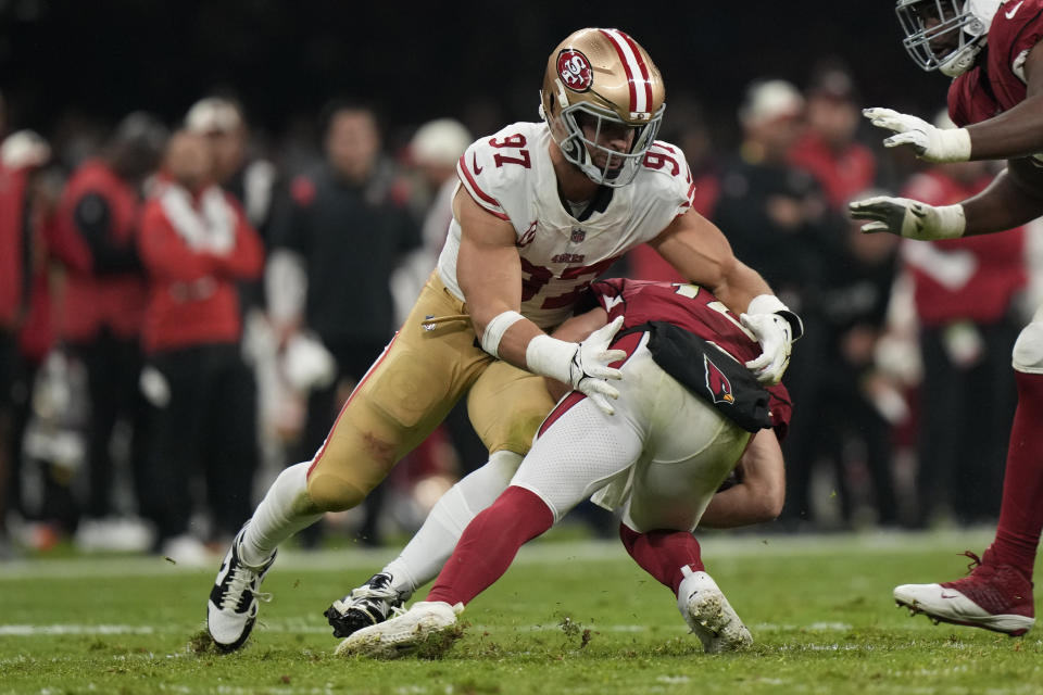 San Francisco 49ers defensive end Nick Bosa, left, sacks Arizona Cardinals quarterback Colt McCoy during the first half of an NFL football game Monday, Nov. 21, 2022, in Mexico City. (AP Photo/Fernando Llano)