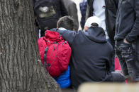 Children wait in front of the Vladislav Ribnikar school after shooting in Belgrade, Serbia, Wednesday, May 3, 2023. A teenage boy opened fire early Wednesday in a school in central Belgrade, causing injuries. (AP Photo/Darko Vojinovic)