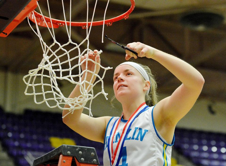 Senior Brooklyn Brandriet takes her turn cutting down the net after Hamlin's girls basketball team defeated Wagner 58-55 in the state Class A championship game on Saturday, March 11, 2023 in the Watertown Civic Arena.