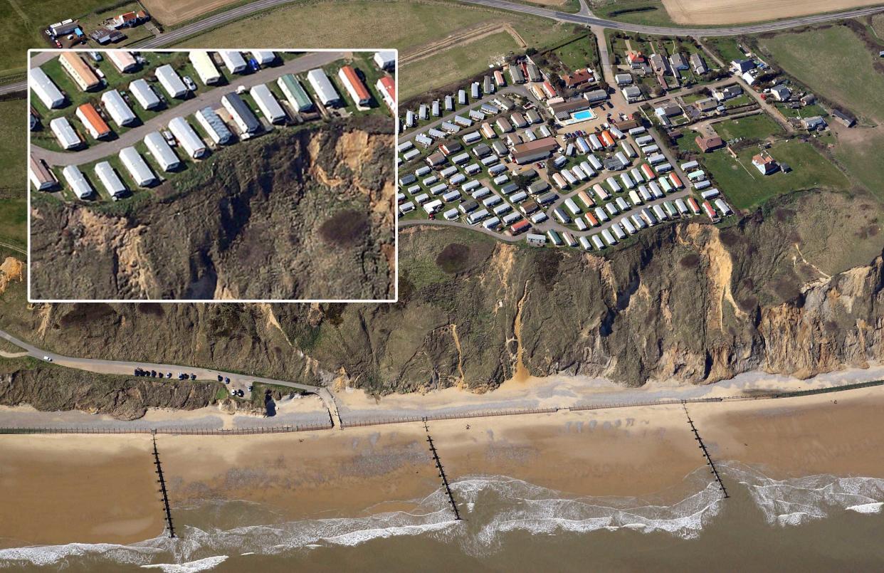 Seaside caravans were left teetering on the edge of a cliff after a huge landslide near Cromer in Norfolk (Picture: SWNS)