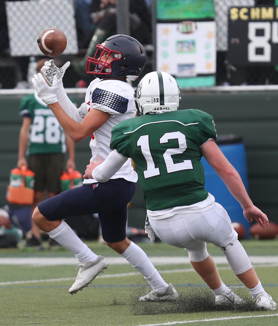 EastchesterÕs Michael Provenzale (10) catches a pass in front of BrewsterÕs Kevin Fox (12) during football action at Brewster High School Sept. 30, 2023. Eastchester won the game 21-0. 