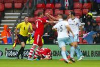 Southampton's Adam Lallana (rear) lies on the pitch after a tackle from West Ham United's Joey O'Brien (right)