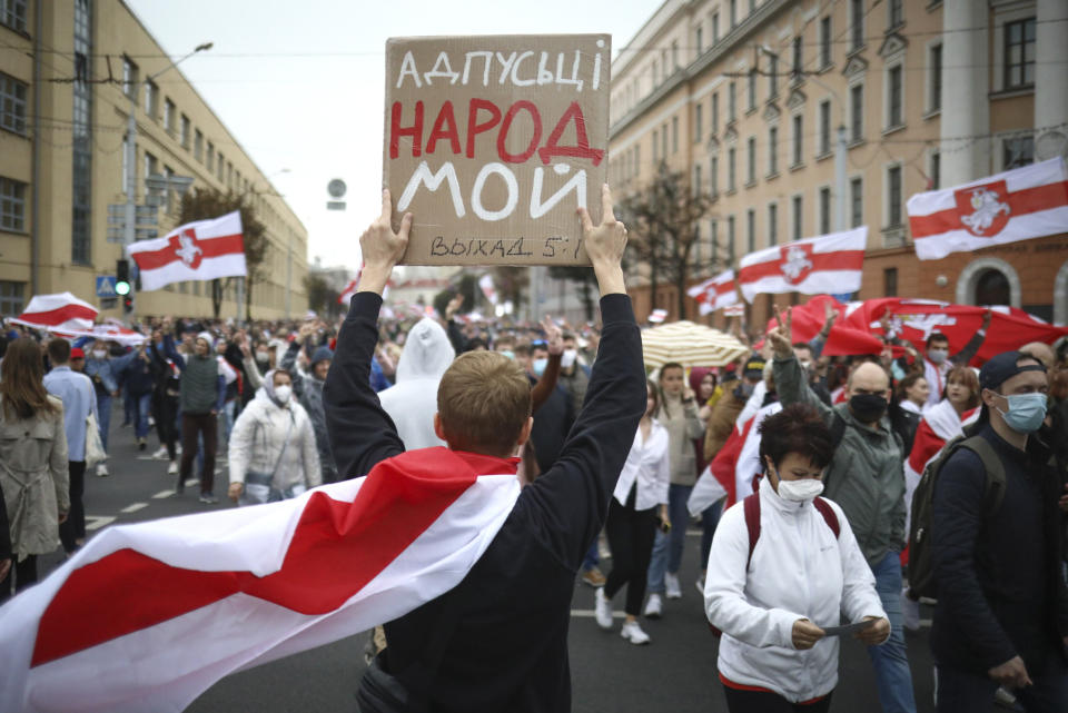 A man holds placard reading "Let my people go" during an opposition rally to protest the official presidential election results in Minsk, Belarus, Sunday, Sept. 27, 2020. Hundreds of thousands of Belarusians have been protesting daily since the Aug. 9 presidential election. (AP Photo/TUT.by)