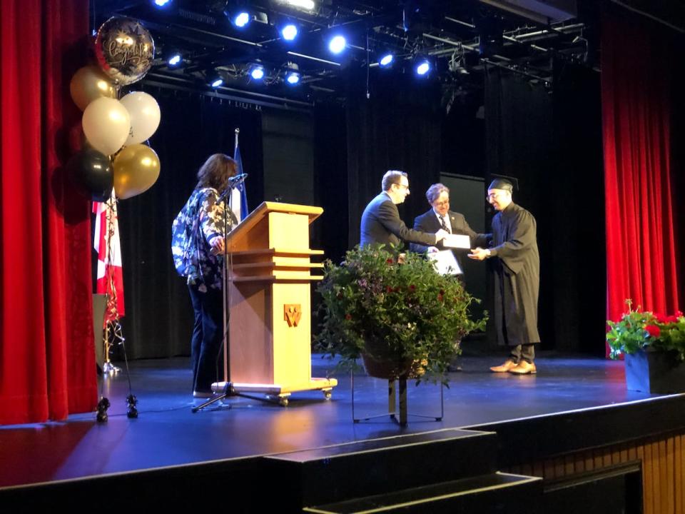 Ferdos Rasuli, a student from CDC Vimont, receives his high school diploma for the second time. Rasuli, an Afghan refugee, first earned his diploma while living in Tajikistan, but needed to redo some credits in Canada, to pursue post-secondary studies.
