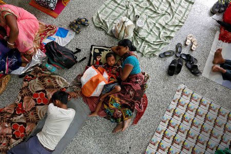 People rest on the floor outside the intensive care unit (ICU) of the Baba Raghav Das hospital in the Gorakhpur district, India August 14, 2017. REUTERS/Cathal McNaughton