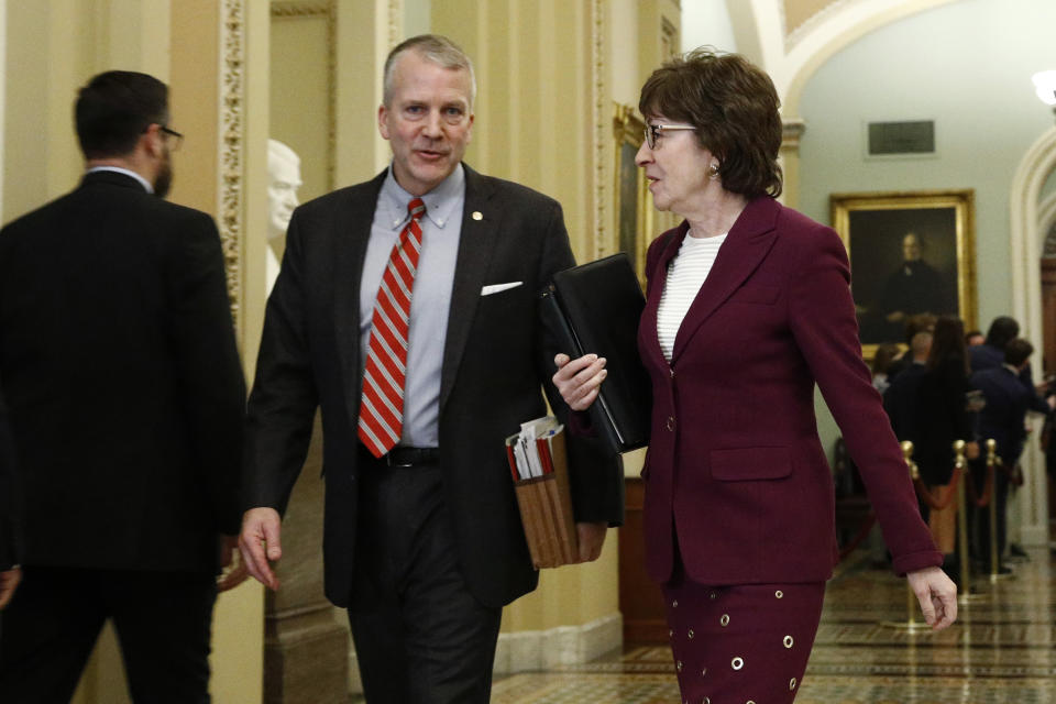 Sen. Susan Collins, R-Maine, right, walks with Sen. Dan Sullivan, R-Alaska, as they make their way to the Senate chamber for the impeachment trial of President Donald Trump at the Capitol, Wednesday, Jan. 22, 2020, in Washington. (AP Photo/Steve Helber)