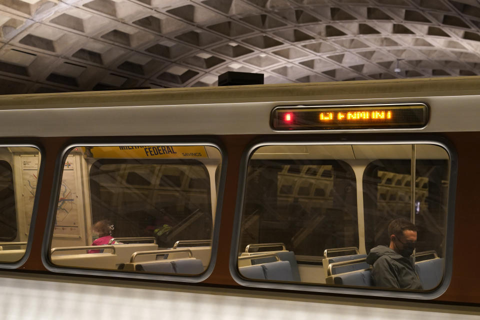 A passenger sits on a train at Metro Center station, Friday, April 23, 2021, in Washington. As President Joe Biden urges more federal spending for public transportation, transit agencies decimated by COVID-19 are struggling with a new uncertainty: how to win passengers back. (AP Photo/Patrick Semansky)