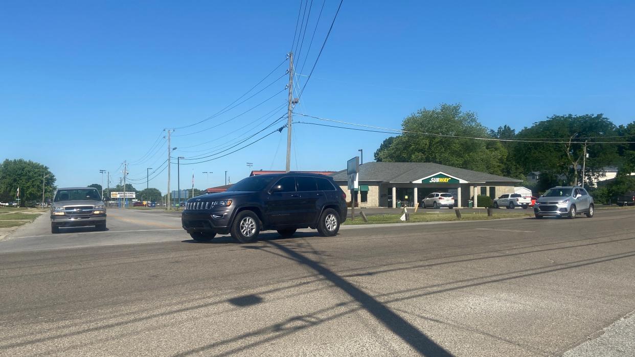 Several vehicles make their way through the Monroe and Carlisle streets in Mooresville.