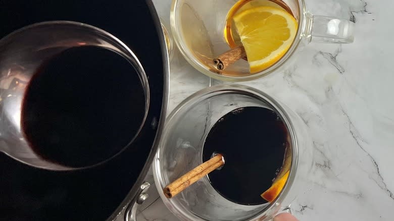 wine and cinnamon in mug with mulled wine