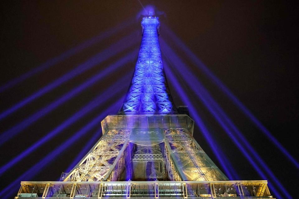 A photo shows the Eiffel Tower lit in the colours of the Ukrainnian flag in a show of support to Ukraine (AFP via Getty Images)