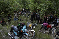 Tenetehara Indigenous men from the Ka’Azar, or Forest Owners, pause to talk about where they'll go next on the Alto Rio Guama reserve in Para state, near the city of Paragominas, Brazil, Tuesday, Sept. 8, 2020. Three Tenetehara Indigenous villages are patrolling to guard against illegal logging, gold mining, ranching, and farming on their lands, as increasing encroachment and lax government enforcement during COVID-19 have forced the tribe to take matters into their own hands. (AP Photo/Eraldo Peres)