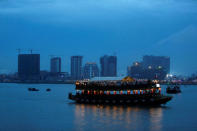 A boat passes buildings under construction on Diamond Island also known as 'Koh Pich', as seen from Tonle Chaktomuk river in Phnom Penh, Cambodia, May 22, 2018. REUTERS/Samrang Pring