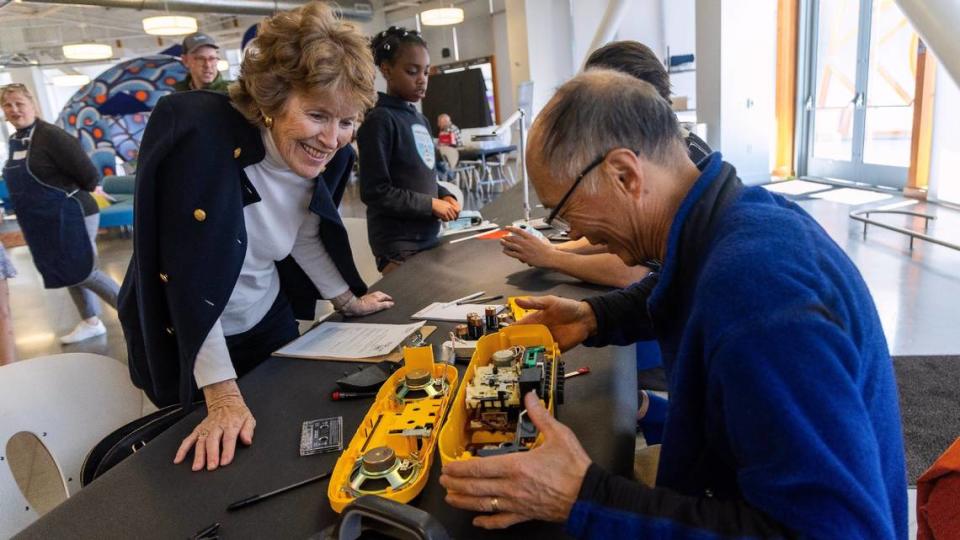 Ramona Higer, left, watches as Andy Huang takes apart her boombox to fix the radio function at Thursday’s “repair cafe.” Sarah A. Miller/smiller@idahostatesman.com