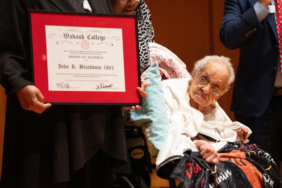 Jeanne Blackburn Burch, 103-year-old granddaughter of John R. Blackburn, accepts an honorary degree for Blackburn from Wabash College president Scott Feller during a series of events honoring the life of John R. Blackburn, the college’s first black student, in Salter Hall at the Fine Arts Center Monday, Feb. 5, 2024, at Wabash College in Crawfordsville, Indiana.