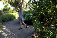 Jenni Odgen, of Los Angeles, walks through an augmented reality (AR) garden titled "Breonna's Garden" honoring the late Breonna Taylor at the Maurice A. Ferre Park next to the Perez Art Museum during Miami Art Week, Friday, Dec. 3, 2021, in Miami. The project was created in a collaboration between artist Lady PheOnix and Taylor's sister Ju'Niyah Palmer. (AP Photo/Lynne Sladky)