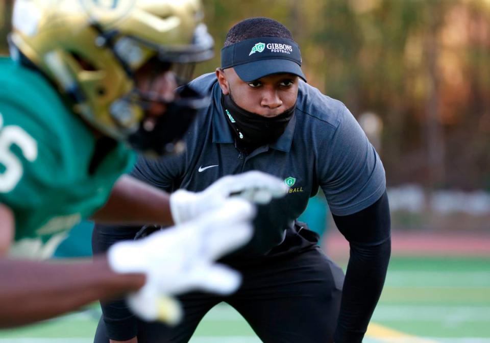 N.C. State linebacker Isaiah Moore watches as Cardinal Gibbons High School football players run drills before the Crusaders’ game against Pine Forest in Raleigh, N.C., Friday, April 16, 2021. Moore is doing a minor at State in coaching. Part of the curriculum required a certain amount of intern hours getting real life coaching experience, which led Moore to volunteer coach at Gibbons this season.