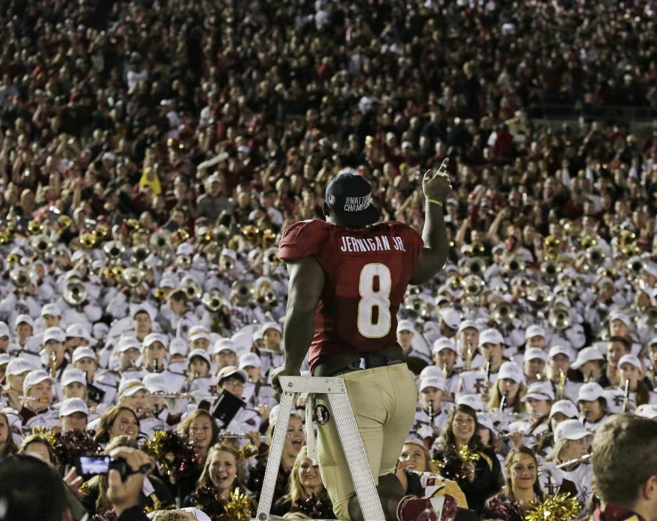 Florida State's Timmy Jernigan celebrates with fans after the NCAA BCS National Championship college football game against Auburn Monday, Jan. 6, 2014, in Pasadena, Calif. Florida State won 34-31. (AP Photo/Chris Carlson)