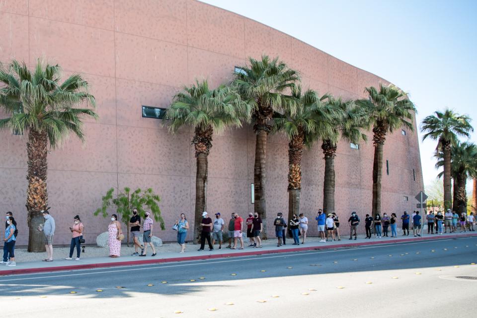 People wait in a line outside of Palm Springs Convention Center to receive the COVID-19 vaccine on Monday, March 29, 2021, in Palm Springs, Calif. Any Riverside County resident or worker had the potential to receive a COVID-19 vaccine to prevent wasting doses that were set to expire the following day. 