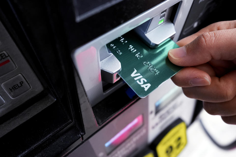 A customer uses a Visa credit card to pay for gasoline at a gas station in Mundelein, Ill., Thursday, Feb. 8, 2024. (AP Photo/Nam Y. Huh)