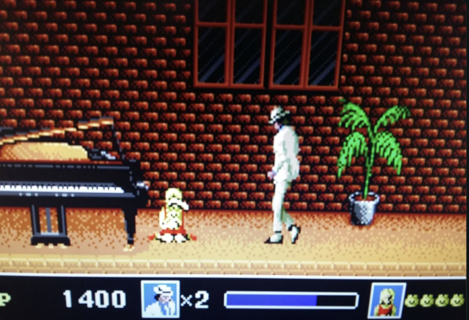 A scene from the Michael Jackson's Moonwalker video game showing Michael in a white suit with his pet chimp, Bubbles