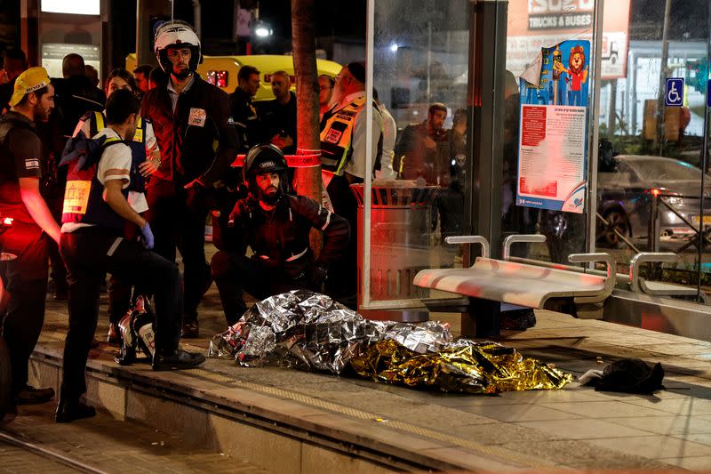 A body lays covered at the scene of what Israeli police say was a stabbing attack in Jerusalem