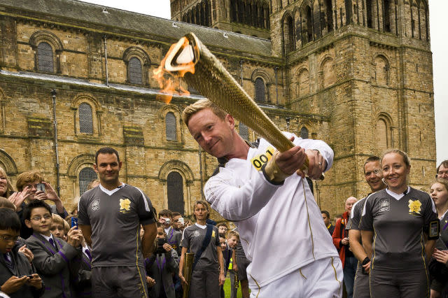 Cricketer Paul Collingwood carries the Olympic Flame on the Torch Relay leg between Durham and Sherburn Hill.