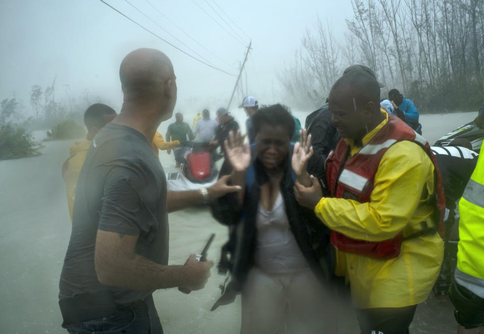 Volunteers rescue several families that arrived on small boats, from the rising waters of Hurricane Dorian, near the Causarina bridge in Freeport, Grand Bahama, Bahamas, Tuesday, Sept. 3, 2019. The storm’s punishing winds and muddy brown floodwaters devastated thousands of homes, crippled hospitals and trapped people in attics. (AP Photo/Ramon Espinosa)