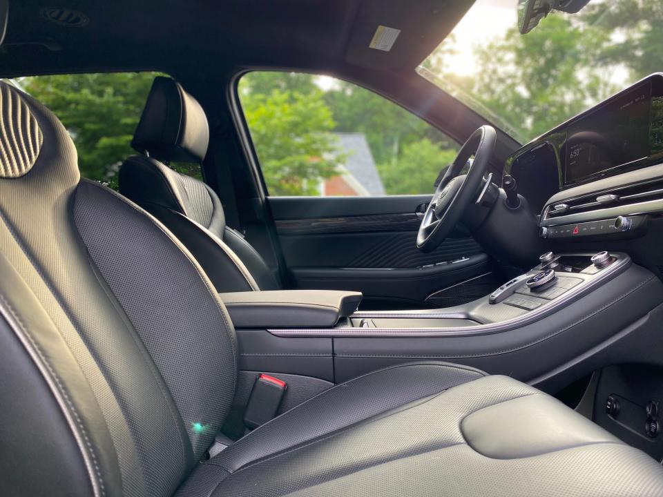 The black Nappa leather lined front cabin of a Hyundai Palisade SUV in Calligraphy trim.