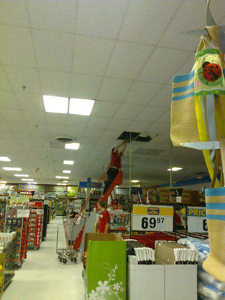 Zellers staff removing wet, damaged tiles from the celing. June, 3rd, 2012.