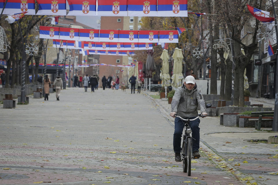 FILE - Serb national flags decorate the main square in ethnically divided town Serb dominated northern Mitrovica on Friday, Dec. 9, 2022. A new mayor has been sworn in in northern Kosovo after a vote that was boycotted by the ethnic Serb minority which dominates the area. Erden Atic, who is from the Albanian majority, took up his post in the northern, Serb-dominated part of the divided city of Mitrovica on Friday May 19, 2023, calling on citizens to cooperate. (AP Photo/Visar Kryeziu, File)