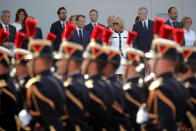 <p>French President Emmanuel Macron, his wife Brigitte Macron, Singapore’s Prime Minister Lee Hsien Loong and members of the French government attend the traditional Bastille Day military parade on the Champs-Élysées in Paris, France, July 14, 2018. (Photo: Philippe Wojazer/Pool/Reuters) </p>