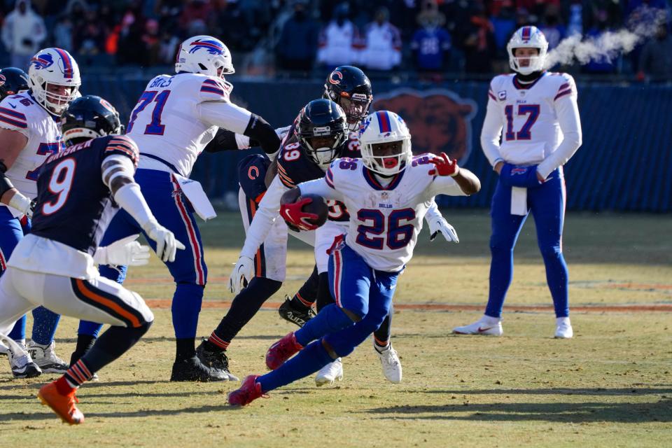 Buffalo Bills running back Devin Singletary (26) cuts away from Chicago Bears cornerback Jaquan Brisker (9) on his way to a touchdown in the second half of an NFL football game in Chicago, Saturday, Dec. 24, 2022. (AP Photo/Charles Rex Arbogast)