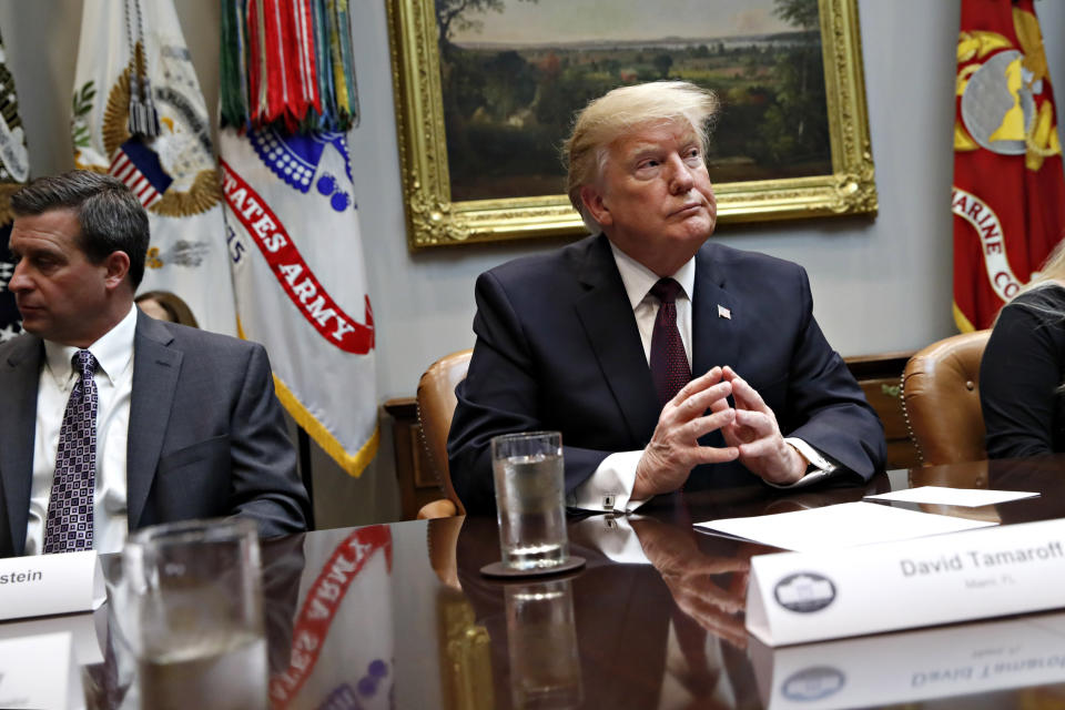 President Donald Trump listens during a healthcare roundtable in the Roosevelt Room of the White House, Wednesday, Jan. 23, 2019, in Washington. At left is David Silverstein, of Denver. (AP Photo/Jacquelyn Martin)