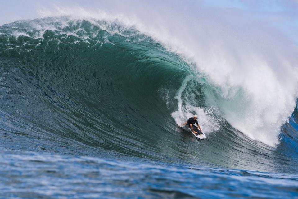 Koa Smith surfs Waimea Bay in the Hawaiian island of Oahu (Photo by Mike Ito, courtesy of MUD\WTR)