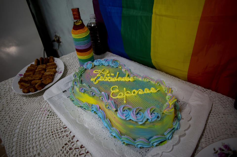 A wedding cake that reads in Spanish "Congratulations wives" awaits the celebration of newlyweds Lisset Diaz Vallejo and Liusba Grajales on their wedding day in Santa Clara, Cuba, Friday, Oct. 21, 2022. The couple, which has been together for seven years, is one of the first to make the decision to get legally married in Cuba following the new Family Code, which opened up everything from equal marriage to surrogate mothers. (AP Photo/Ismael Francisco)