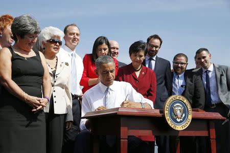 U.S. President Barack Obama signs a proclamation designating of 346,000 acres of the San Gabriel Mountains as a national monument in San Dimas, California October 10, 2014. REUTERS/Kevin Lamarque